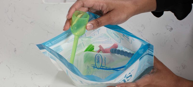Person putting items in Microwave Sterilizer Bag