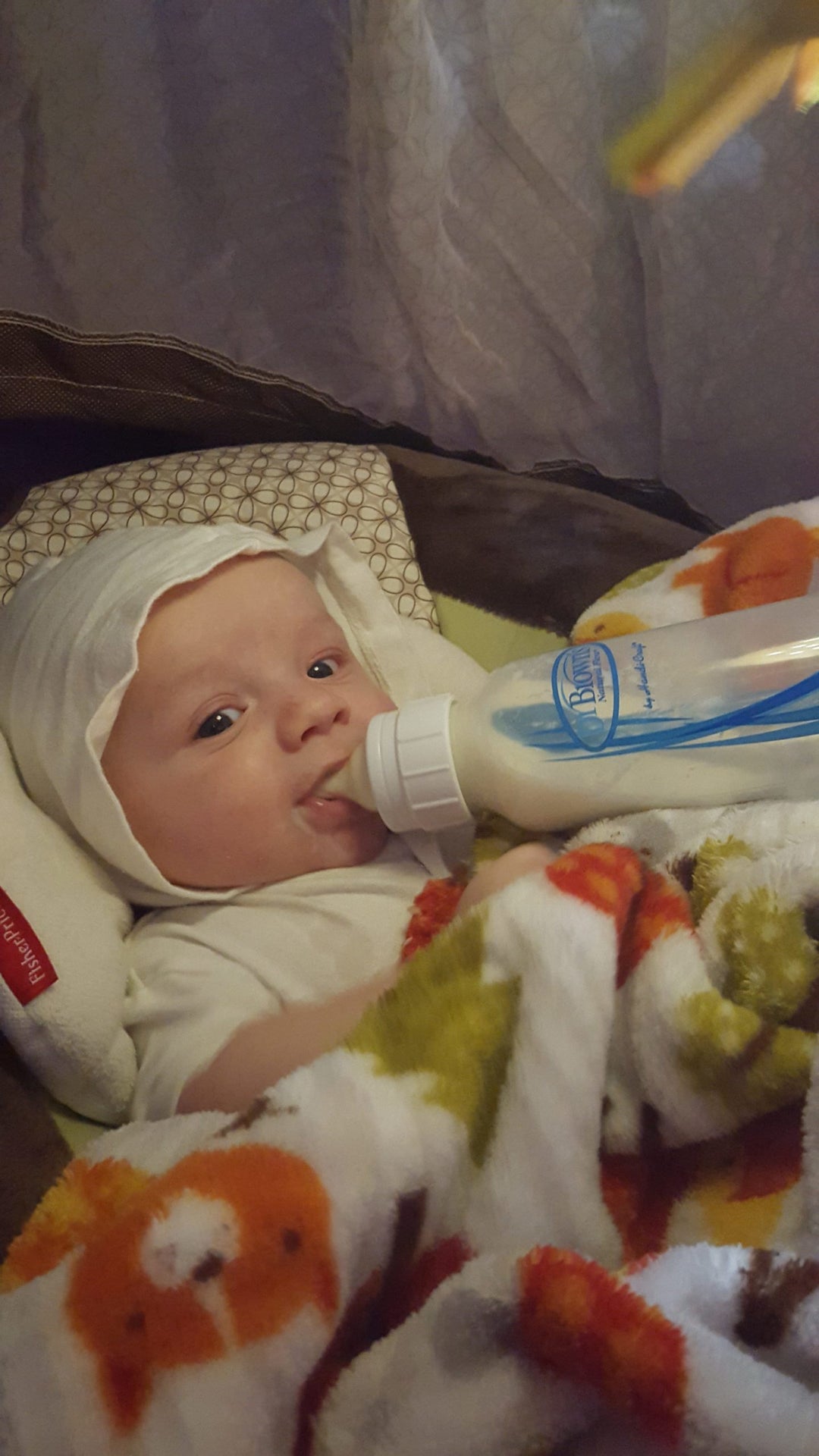 Xander drinking from Dr. Brown's bottle