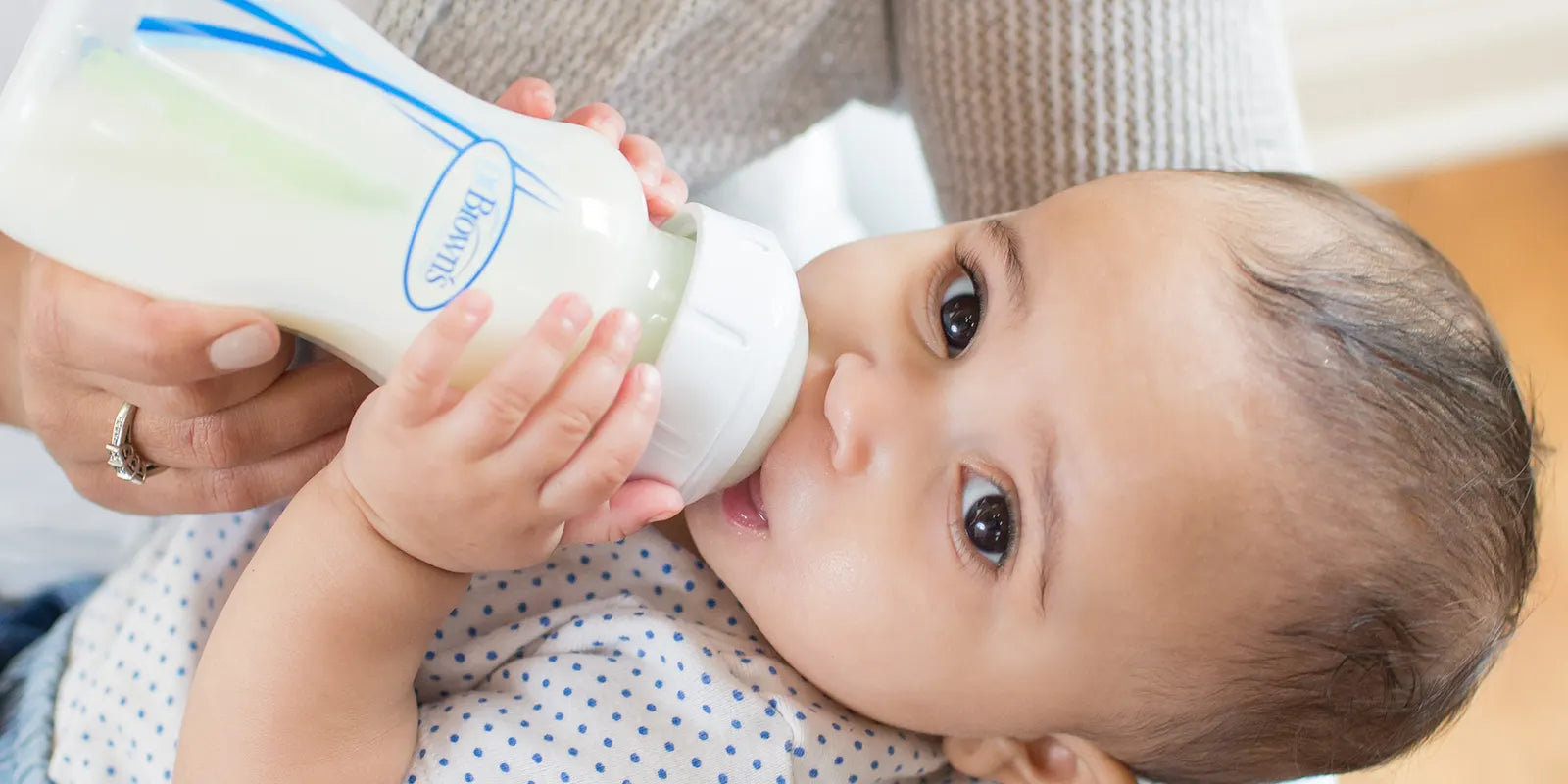 Baby drinking from a Dr. Brown's baby bottle