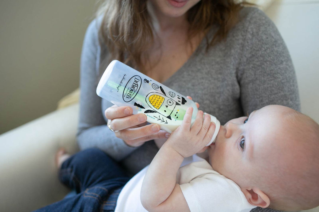 Parent bottle feeding infant