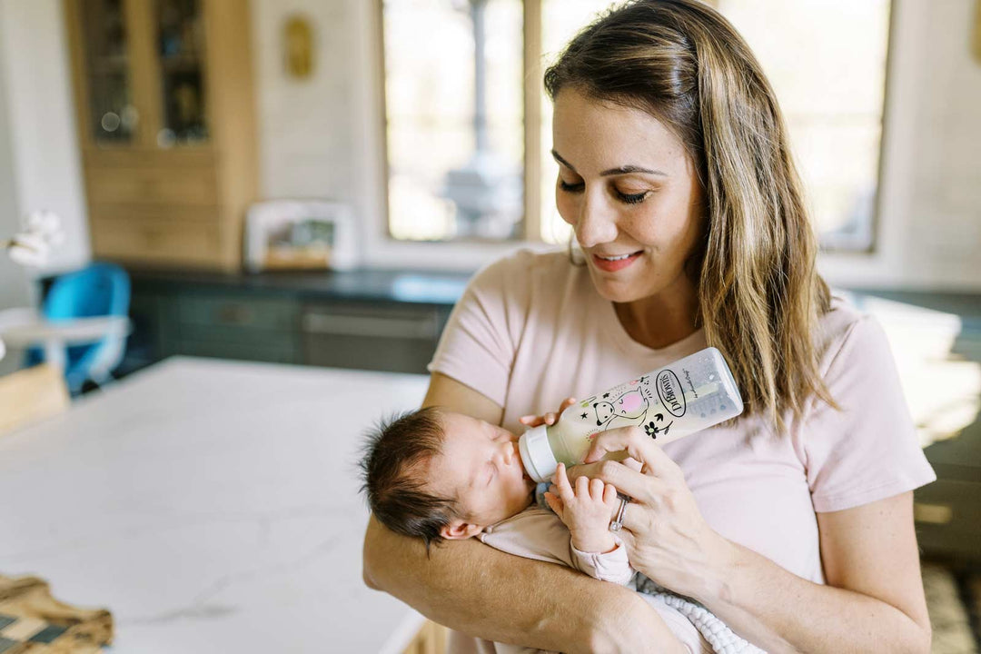 Parent feeding infant with bottle