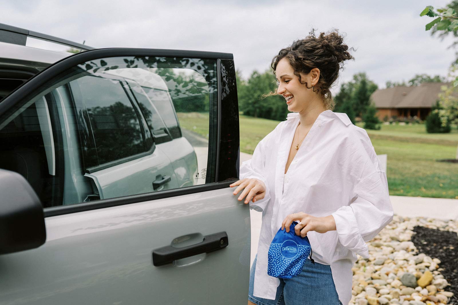 Mother preparing for a trip and holding a breast pump travel bag