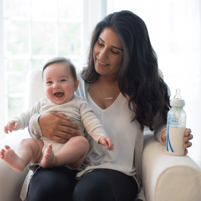 women holding smiling baby