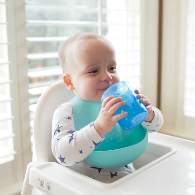 baby drinking from blue cup