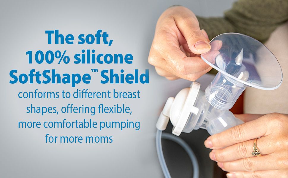 Close-up of hands holding a silicone breast pump shield, highlighting its flexibility. Blue text reads: "The soft, 100% silicone SoftShape™ Shield conforms to different breast shapes, offering flexible, more comfortable pumping for more moms.