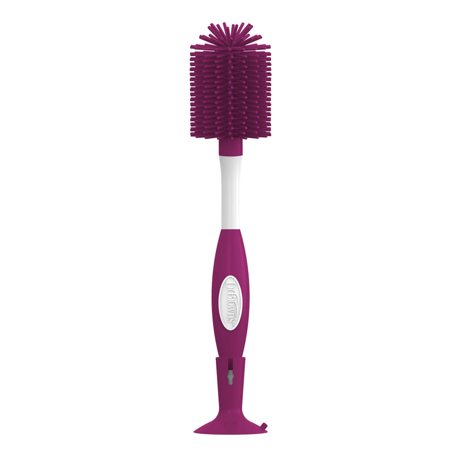 A dark pink and white bottle brush with a suction base