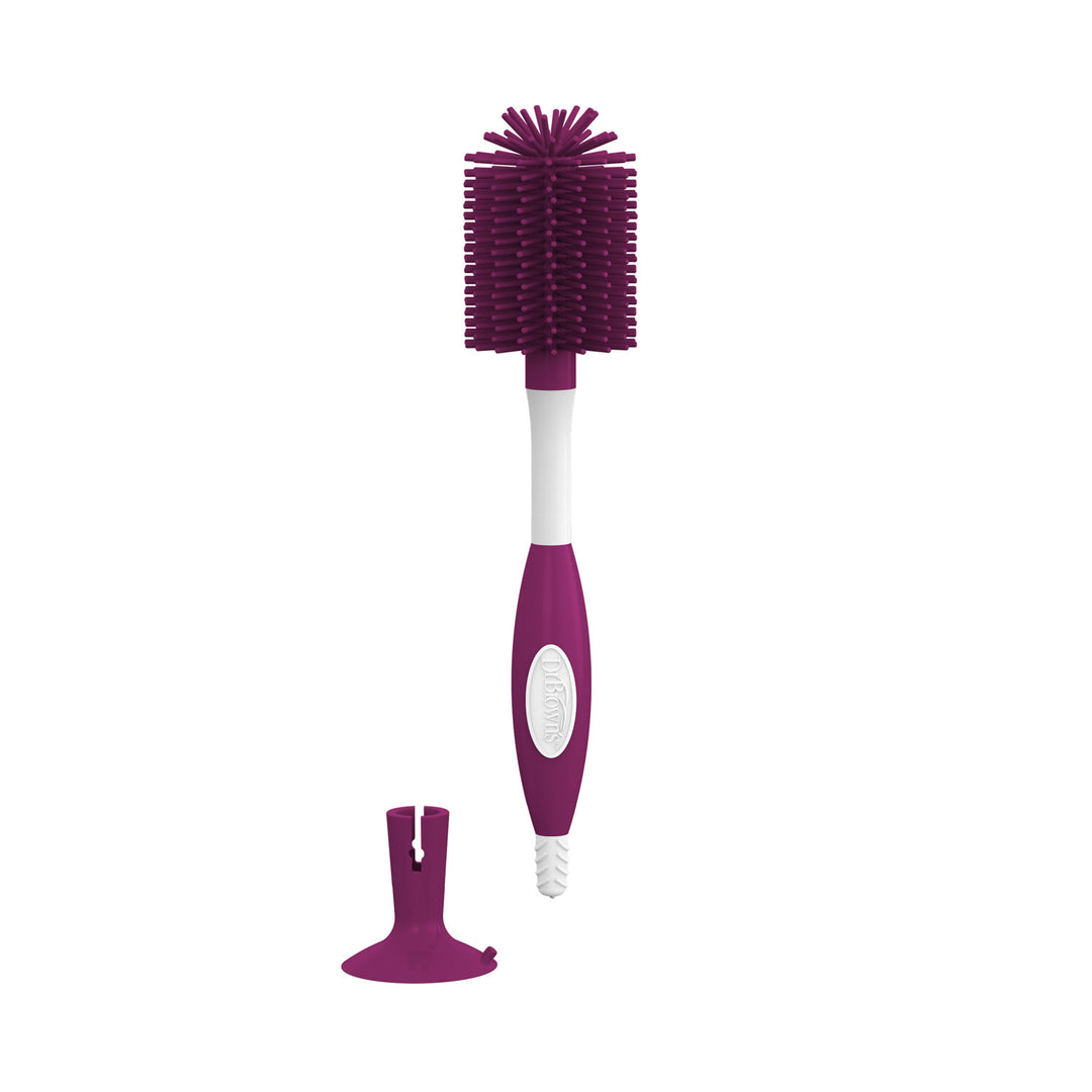 A dark pink and white bottle brush with a separate suction cup accessory