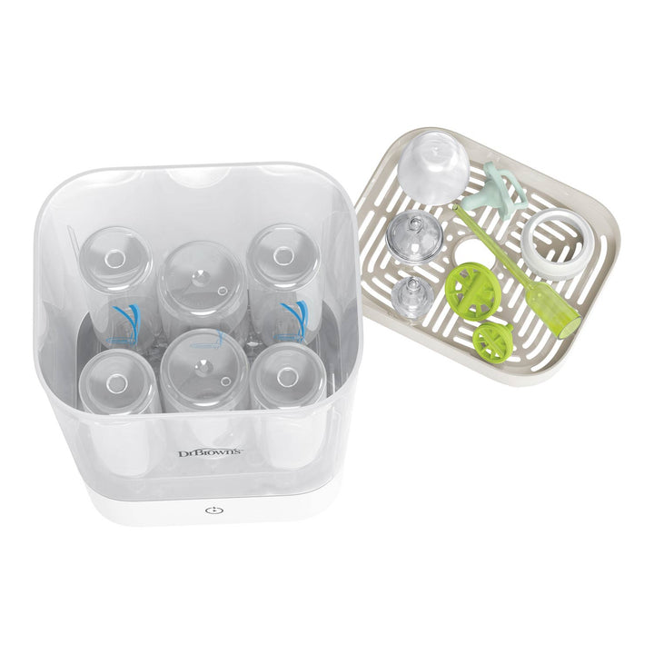 Dr. Brown's baby bottle sterilizer and cleaning tray set on a white background, showing the clear plastic sterilizer container with six bottles inside and the white slotted cleaning tray with green and clear accessories.