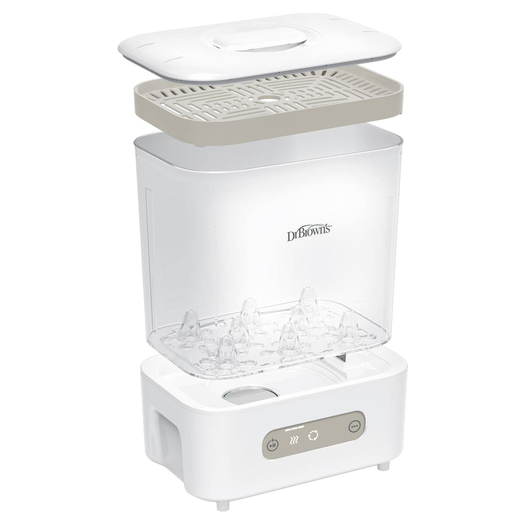 Dr. Brown's steam sterilizer and dryer shown in an exploded view, displaying its white plastic body, clear water tank, beige inner tray, and white lid