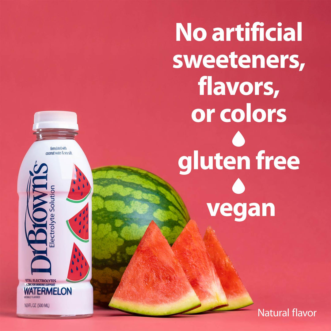 A bottle of Dr. Brown's Watermelon electrolyte solution stands next to a whole watermelon and three watermelon slices on a pink background, with text reading 'No artificial sweeteners, flavors, or colors', 'gluten free', and 'vegan'.