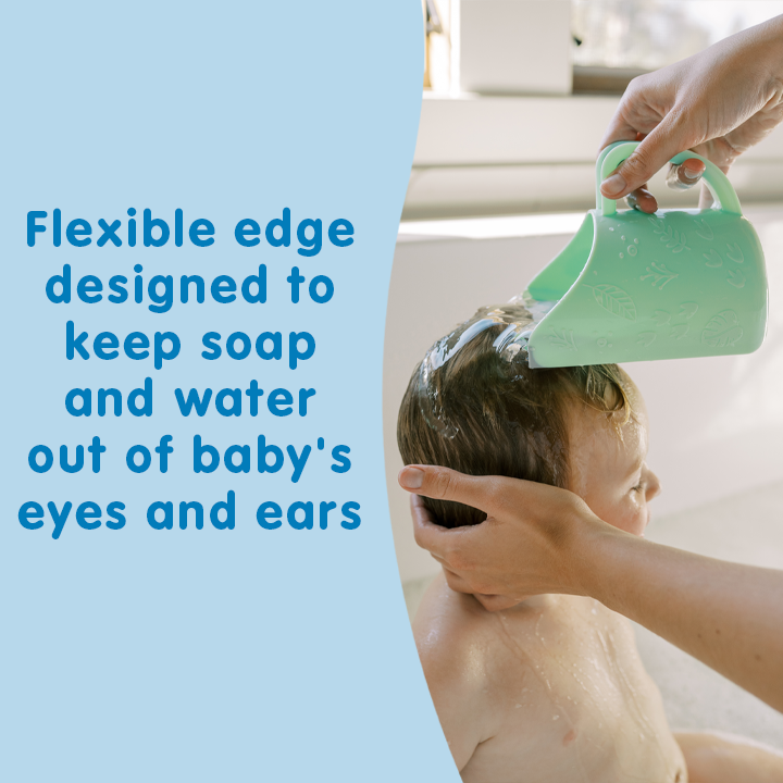 A baby shower scene with a person holding a baby while another hand uses a flexible green scoop to rinse soap and water from the baby's hair. Blue text on the left reads, 'Flexible edge designed to keep soap and water out of baby's eyes and ears.