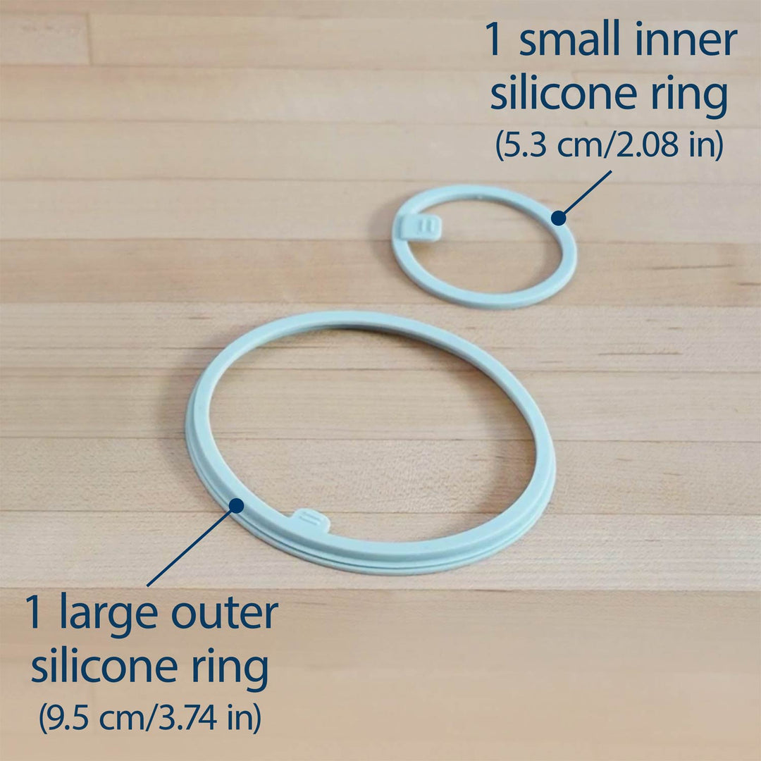 Two silicone rings labeled '1 large outer silicone ring' and '1 small inner silicone ring' on a wooden surface.