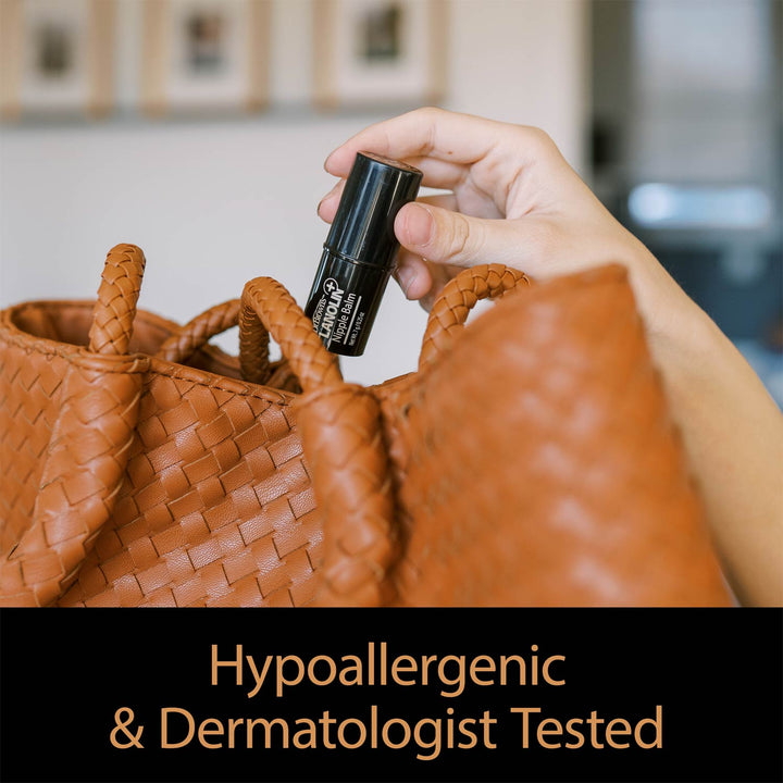 Person holding Lanolin Nipple Balm container next to a brown woven bag with 'Hypoallergenic & Dermatologist Tested' text.