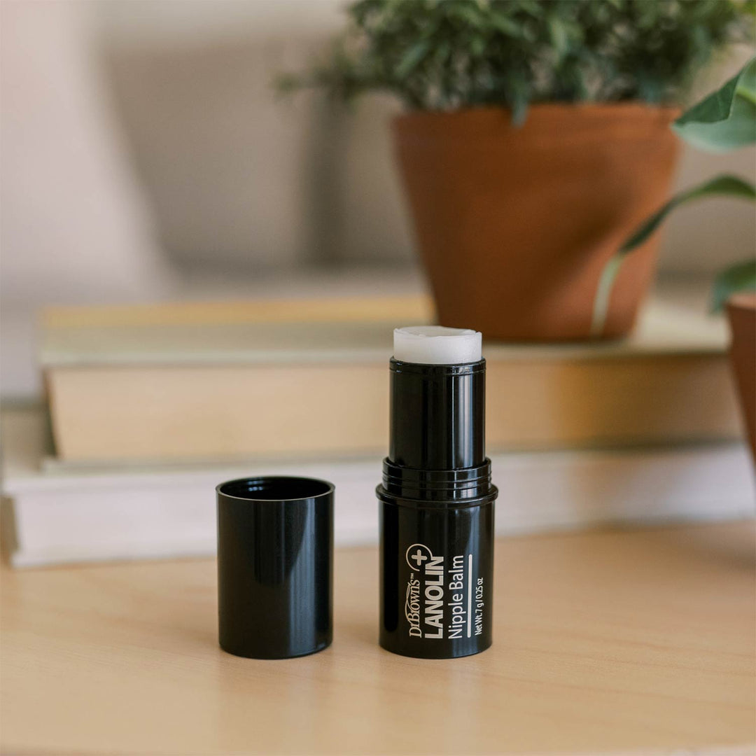 Lanolin Nipple Balm stick with on a coffee table