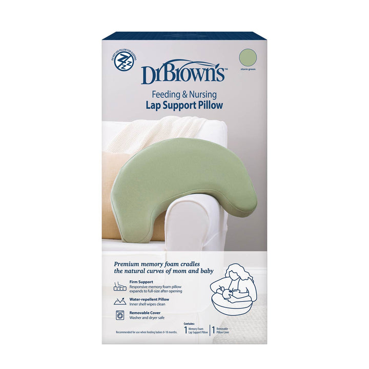Dr. Brown’s™ Feeding & Nursing Lap Support Pillow packaging shows a light green, crescent-shaped pillow on a chair, with product details and a small image of a mother holding her baby. Brand: Dr. Brown's.
