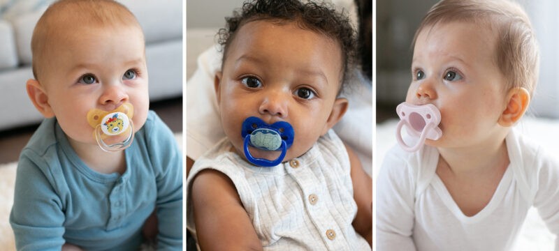 Three babies with Dr. Brown's pacifiers