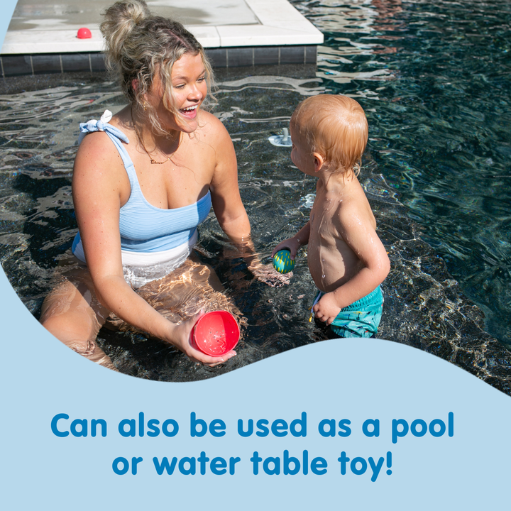 An adult and a young child play with Dr. Brown’s™ CleanUp™ Float & Hatch Dino Eggs in a pool. Text reads: "Doubles as a baby bath toy or water table toy!.