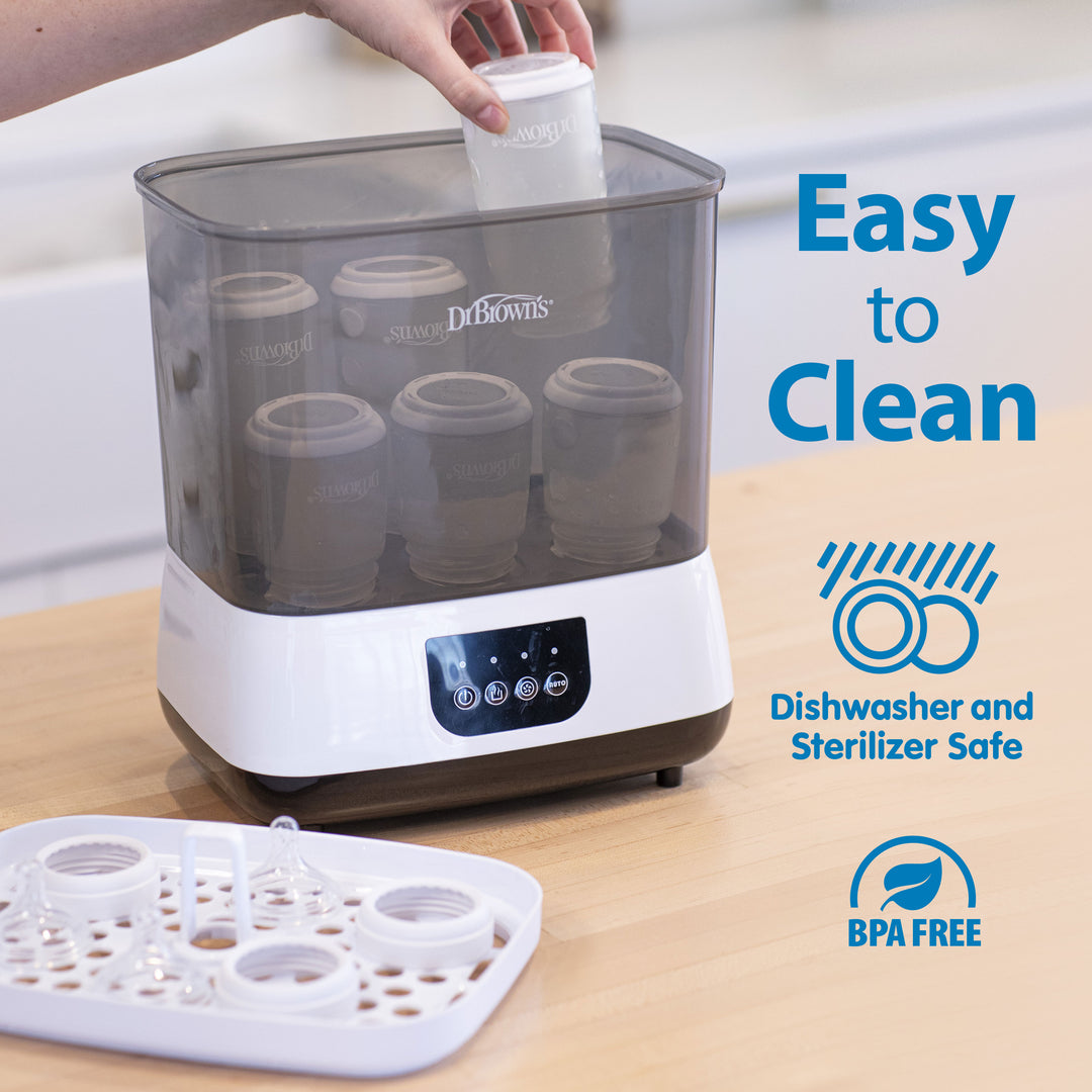 Dr. Brown's sterilizer with bottles on a wooden surface, labeled 'Easy to Clean' and 'BPA Free'.
