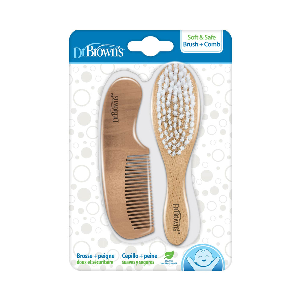 The packaging for Dr. Brown's Soft and Safe Baby Brush + Comb set, ideal for cradle cap care, includes a wooden comb with fine teeth and a baby brush with soft white bristles. The blue and white design presents product details in various languages.