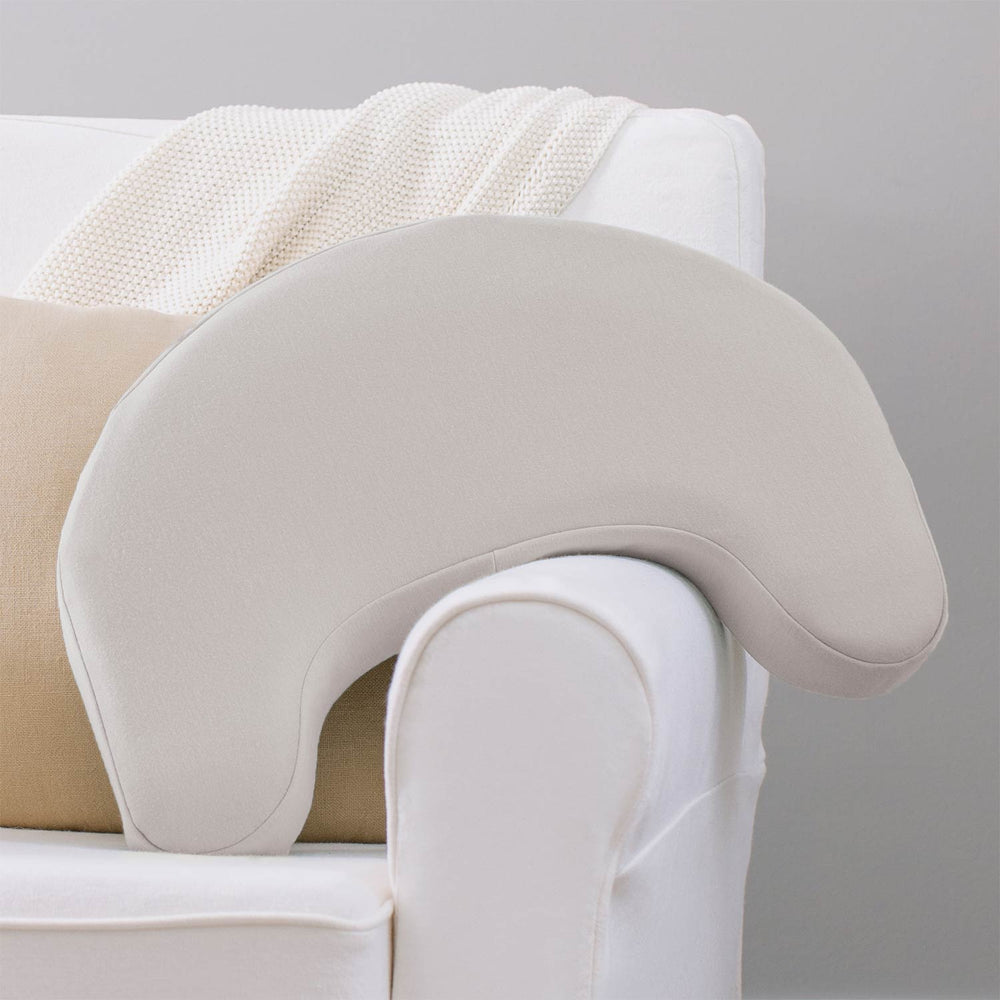 Gray Feeding and Nursing Lap Support Pillow resting against a sofa