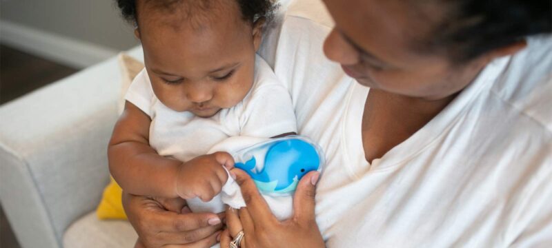 Parent applying Cold Compress on infant