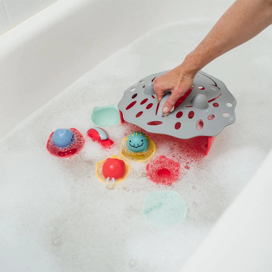 Parent using Dino-Scoop Bath Toy Organizer