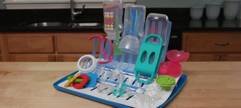 Folding drying rack sitting on counter with items drying on it