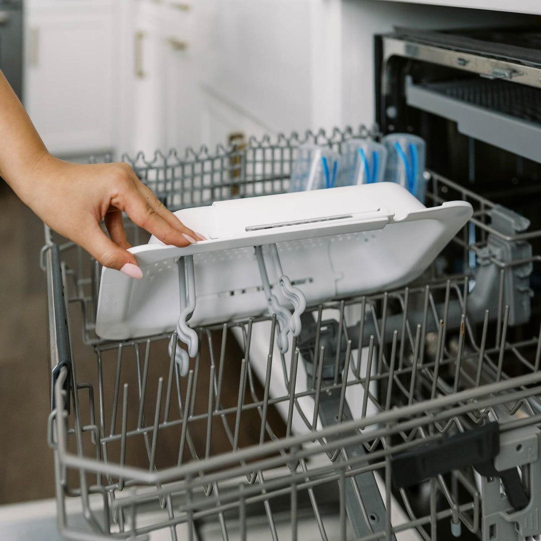 Person placing a sink caddy into the dishwasher