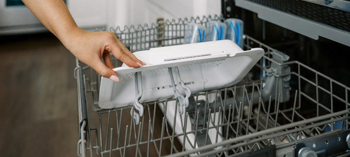 Person loading a dishwasher with a Sink Caddy