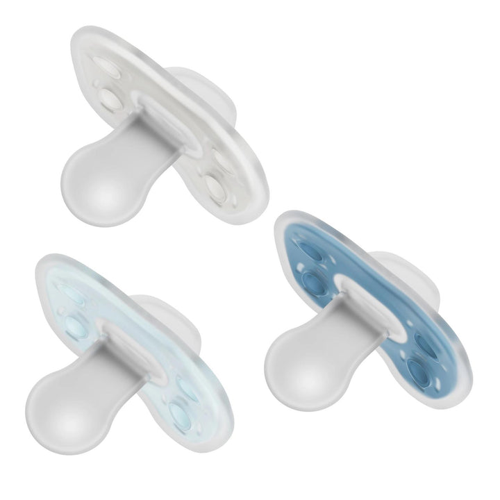 Dr. Brown's® Advantage™ One-Piece Silicone Pacifier – 3-Pack is shown in white, light blue, and blue. Each pacifier features a rounded nipple, flat shield, and seamless one-piece design for baby's comfort on a white background.
