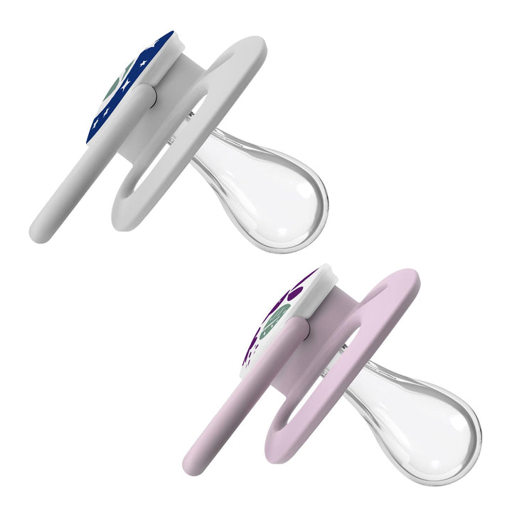 Dr. Brown's™ Advantage™ Glow-in-the-Dark Pacifiers, 2 Count, feature digital thermometers with clear silicone nipples and LCD displays. The upper soother has a dark blue and white cover, while the lower one glows in light lavender and white.