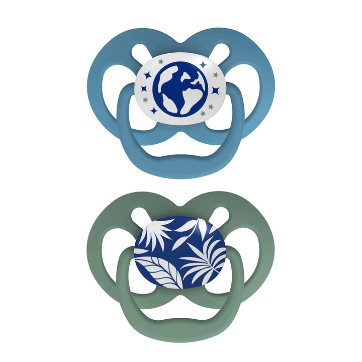 Dr. Brown's™ Advantage™ Glow-in-the-Dark Pacifiers 2 Count set includes one light blue pacifier with glowing globe and stars design and another green pacifier with a blue leaf pattern.