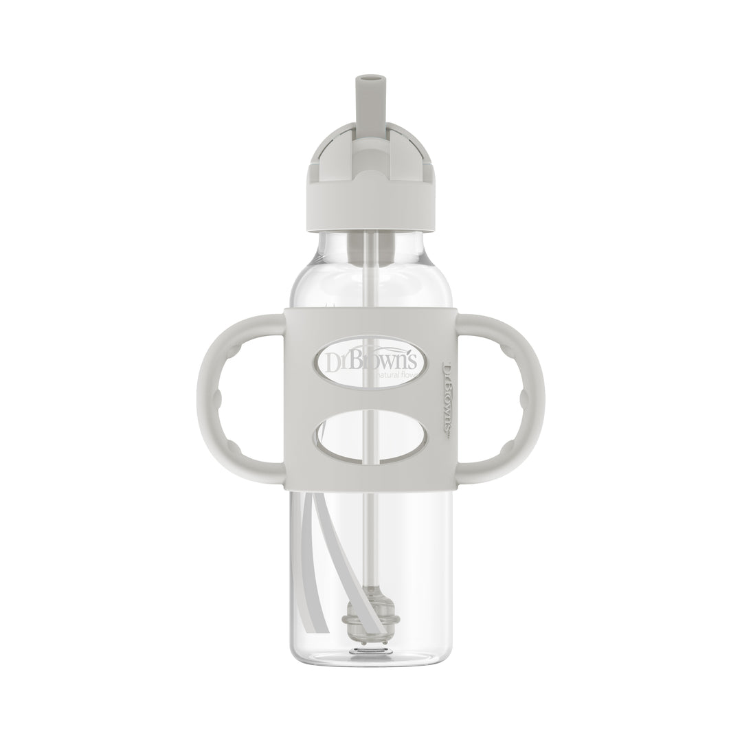 The Dr. Brown's™ Milestones™ Narrow Sippy Straw Bottle with Silicone Handles, 8 oz/250 mL, is a transparent bottle featuring a gray, two-handled silicone grip and a built-in straw to encourage independent drinking skills. It comes with a spill-proof lid and a flip-top spout, ideal for toddlers, while prominently displaying the Dr. Brown's branding on the front.