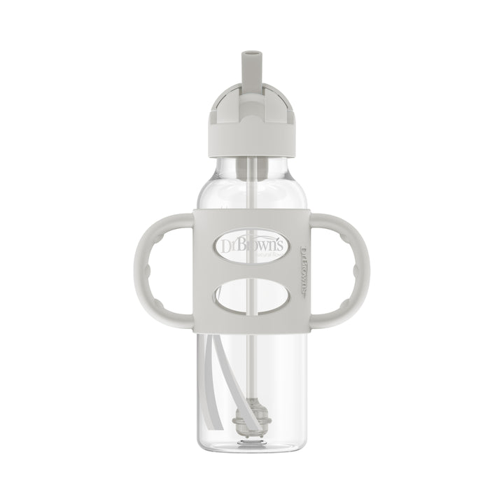 The Dr. Brown's™ Milestones™ Narrow Sippy Straw Bottle with Silicone Handles, 8 oz/250 mL, is a transparent bottle featuring a gray, two-handled silicone grip and a built-in straw to encourage independent drinking skills. It comes with a spill-proof lid and a flip-top spout, ideal for toddlers, while prominently displaying the Dr. Brown's branding on the front.