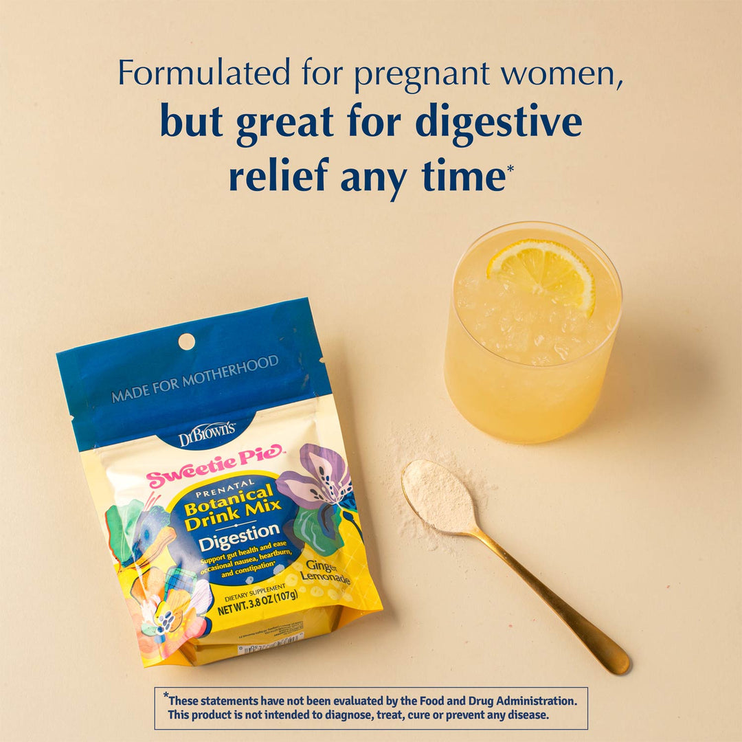 Dr. Brown's Sweetie Pie herbal digestion drink mix pouch shown next to a glass of yellow iced drink with a lemon slice and a gold spoon with powder, on a beige background with promotional text.