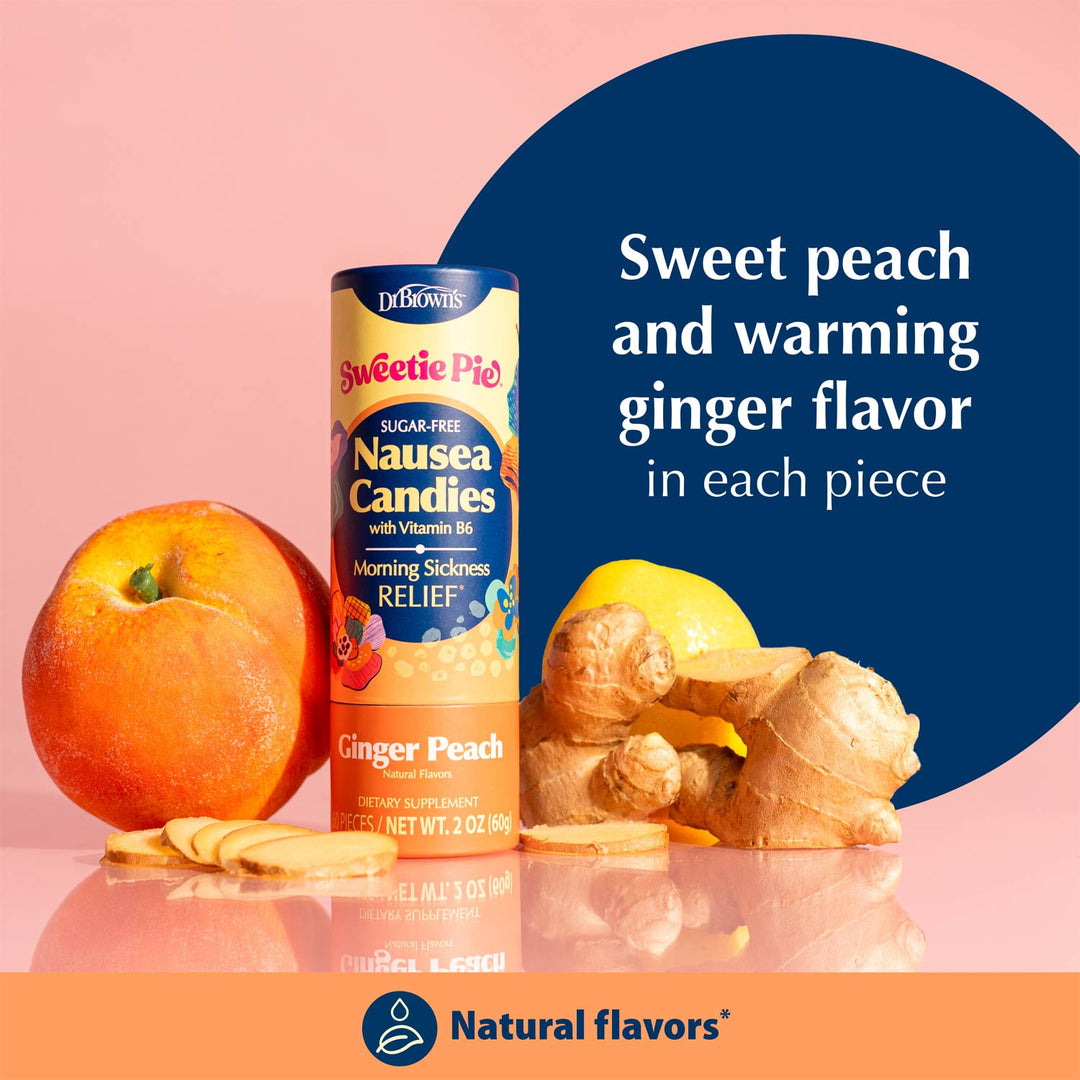 A bottle of Dr. Brown's Sweetie Pie Nausea Candies in Ginger Peach flavor is displayed with a fresh peach, ginger root, and slices on a pink background with a dark blue graphic circle containing flavor text.