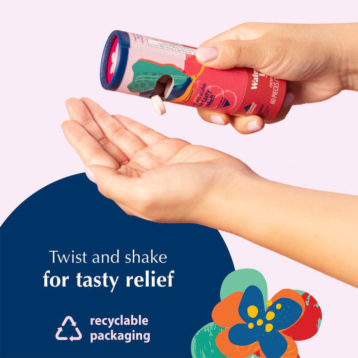 A person holds a cylindrical product tube over their open palm, with Nausea Candies being dispensed. The tube is pink with colorful abstract graphics.