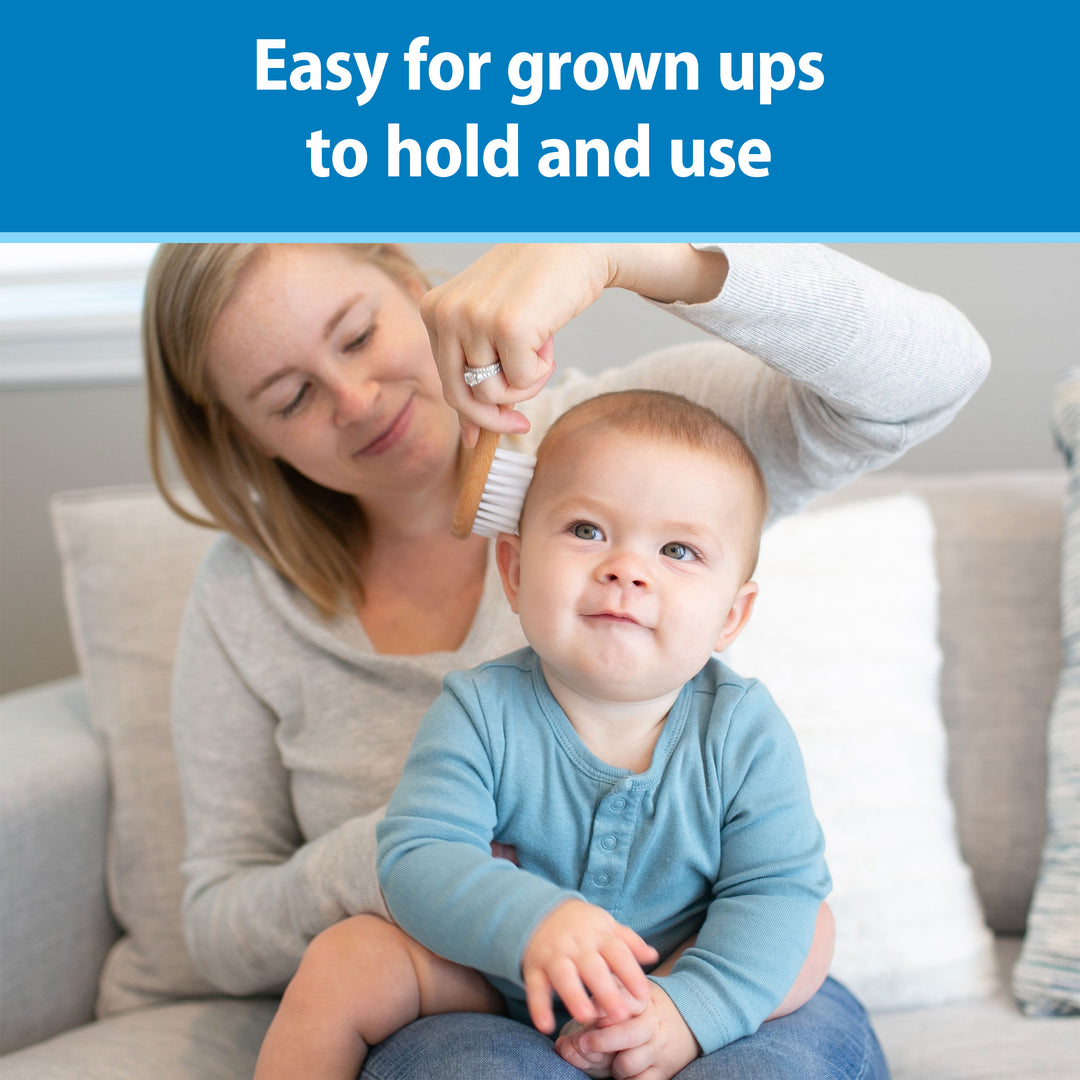Woman brushing a baby's hair with a text overlay about ease of use. Text at the top says, "Easy for grownups to hold and use."