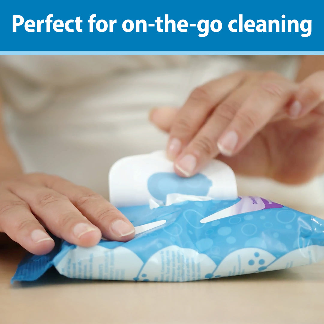 Person opening a package of cleaning wipes, Dr. Brown's Tooth and Gum Wipes, with text 'Perfect for on-the-go cleaning' at the top. 
