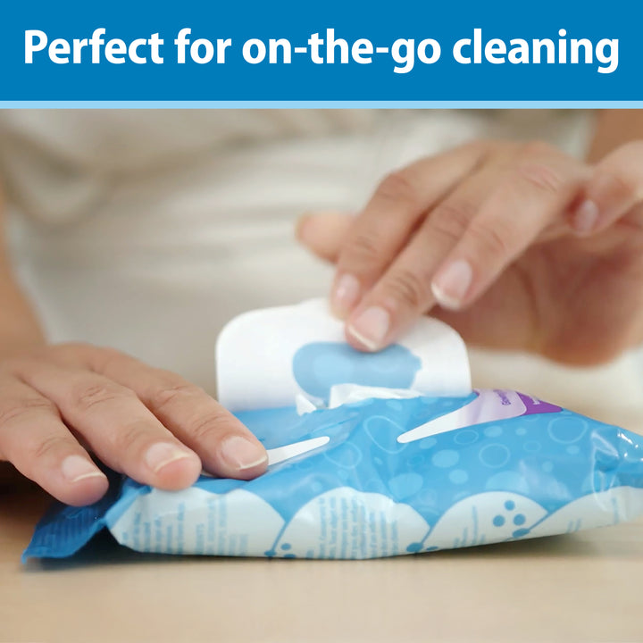 Person opening a package of cleaning wipes, Dr. Brown's Tooth and Gum Wipes, with text 'Perfect for on-the-go cleaning' at the top. 