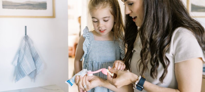 Dr. Brown's toothpaste with mom and daughter and Dr. Brown's Flamingo Toothbrush