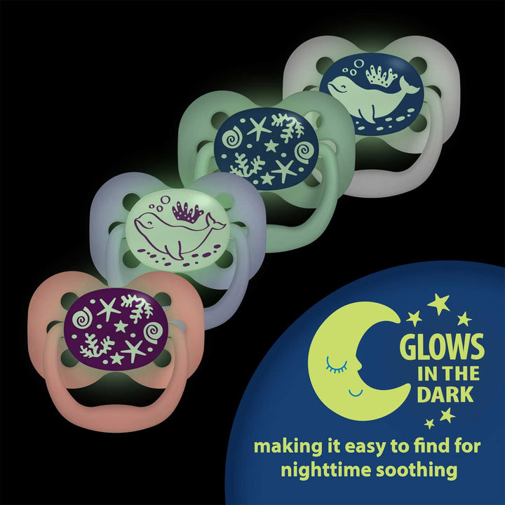 Two Dr. Brown's™ Advantage™ Glow-in-the-Dark Pacifiers, featuring sea-themed designs with whales and starfish, are perfectly lined up. Highlighted by a crescent moon icon, the phrase "Glows in the dark" ensures that these pacifiers are easy to locate for nighttime soothing.