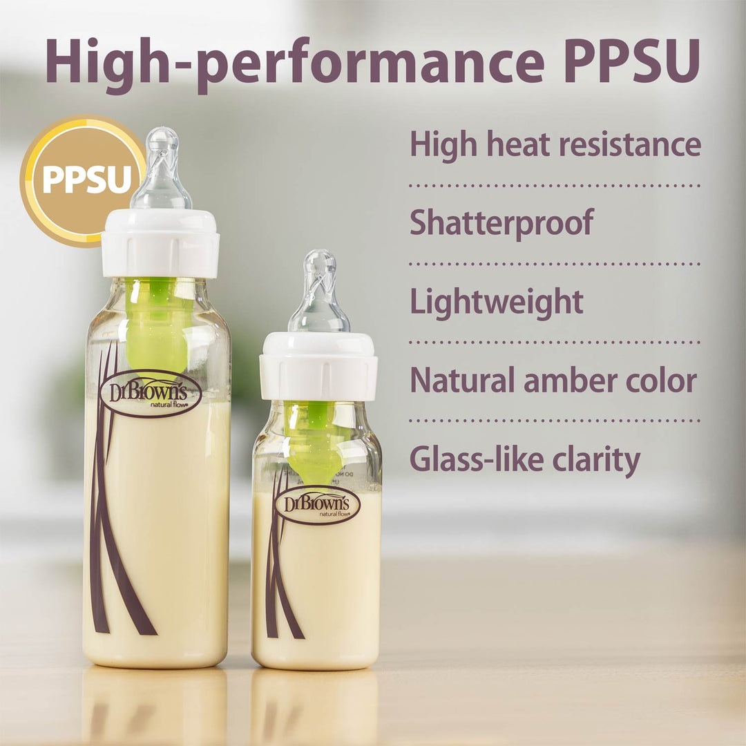 Two Dr. Brown's PPSU baby bottles with white caps and green inner liners, shown on a light surface with promotional text highlighting high heat resistance, shatterproof quality, lightweight design, natural amber color, and glass-like clarity.