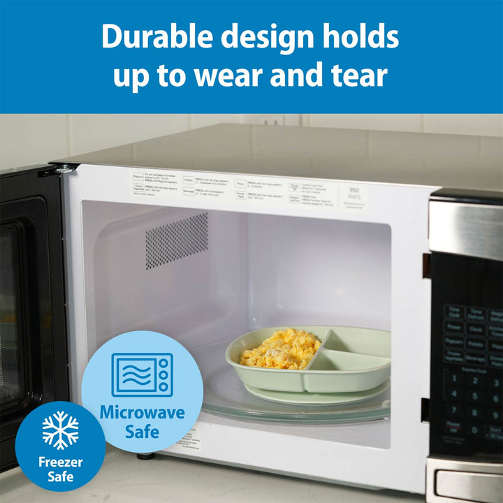 White microwave oven with open door showing a mint No-Slip Divided Suction Plate inside, plus marketing text reading 'Durable design holds up to wear and tear' and badge graphics for 'Microwave Safe' and 'Freezer Safe'.