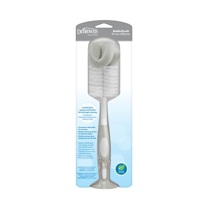 Dr. Brown’s Natural Flow® Baby Bottle Brush, a parent-favorite from Dr. Brown's, showcases a stylish gray and white bristle design and includes a built-in nipple cleaner along with an ergonomic gray handle. The packaging offers detailed information about its bottle cleaning capabilities in both English and French.