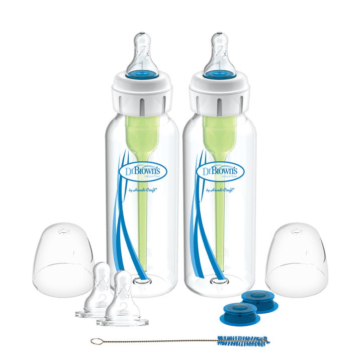 The Dr. Brown's® Specialty Feeding System, 2 Count, by Dr. Brown's includes two baby bottles featuring blue accents and green internal vent systems specifically crafted to address oral feeding challenges. This set also comes with extra nipples, white bottle caps, blue discs, and a convenient cleaning brush for effective feeding management.