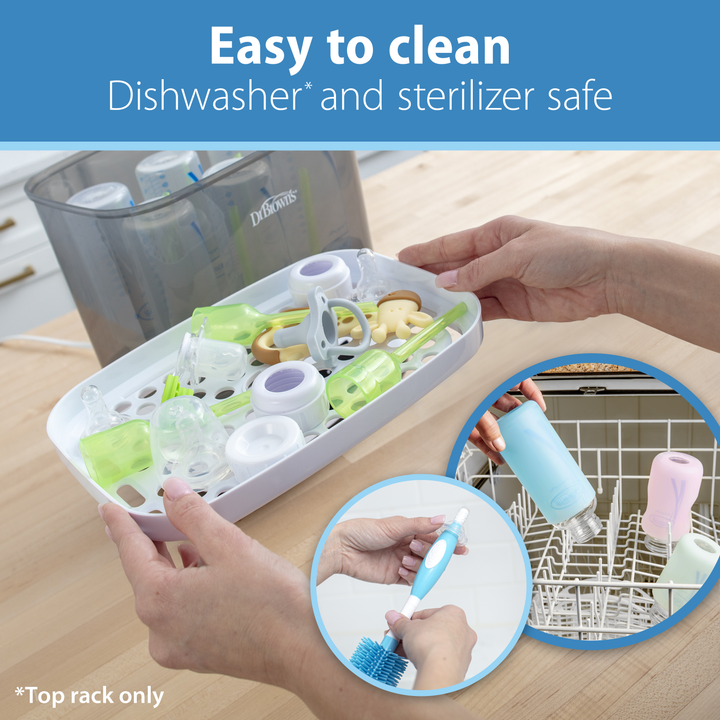 A person places Dr. Brown's Natural Flow® Wide-Neck Baby Bottle and accessories into a dishwasher rack. Text reads: "Easy to clean, Dishwasher* and sterilizer safe," with a note: "*Top rack only." An inset shows a hand cleaning the Dr. Brown’s anti-colic silicone nipple with a brush.