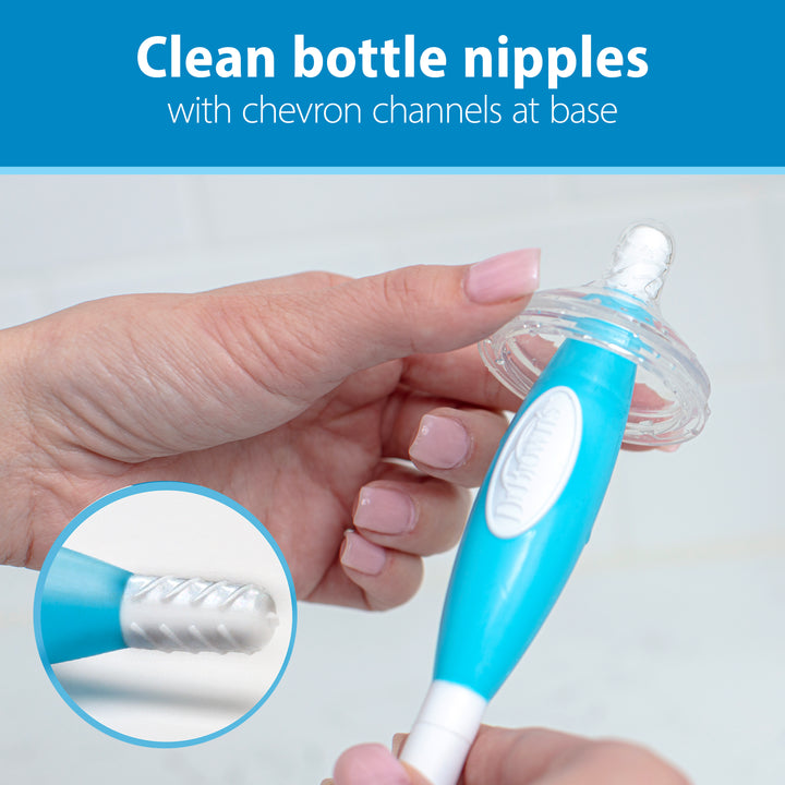 Using Dr. Brown’s™ Soft Touch Bottle Brush, made by Dr. Brown's, a person cleans a baby bottle nipple effortlessly. This brush is designed with durable bristles and a blue handle for effective, scratch-free cleaning while incorporating chevron channels at the base for added efficiency. Text at the top reads, "Clean bottle nipples with chevron channels at base.