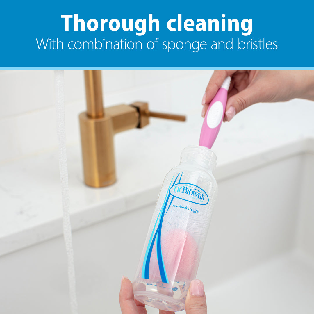 A popular choice among parents, the Dr. Brown’s Natural Flow® Baby Bottle Brush combines a pink and white design with both sponge and bristles to effectively clean baby bottles. In the background, a gold faucet gleams as the text highlights, "Thorough cleaning with combination of sponge and bristles.