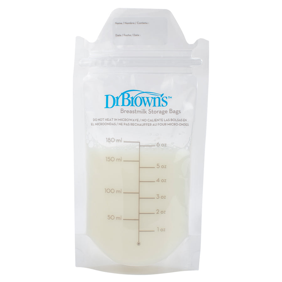 A clear, upright Dr. Brown's Breast Milk Storage and Freezer Bag is filled with breast milk, featuring measurement markings in ounces and milliliters, as well as a white label area for name, date, and contents at the top.